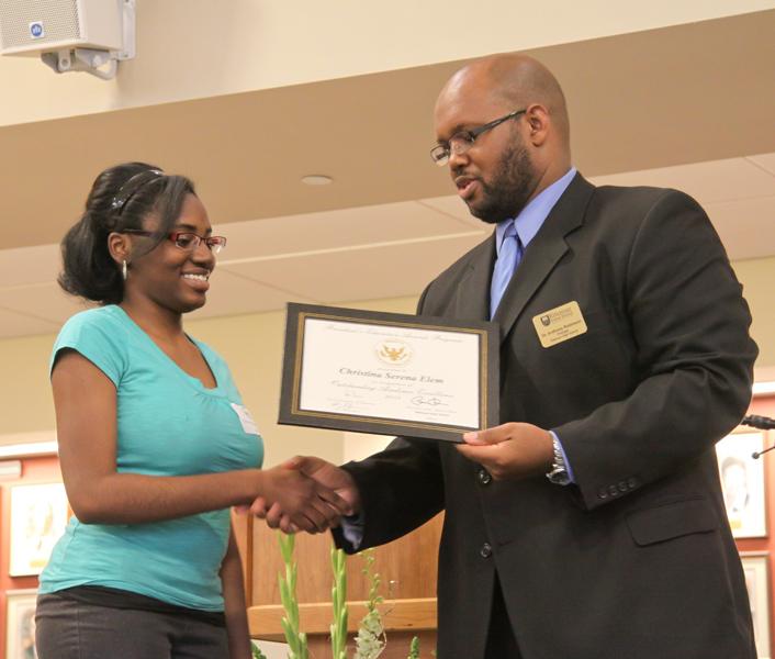 Senior Christina Elem accepts her Presidential Education Award from Principal Anthony Robinson.
