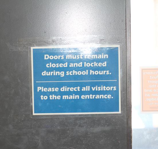 Signs like these hang around all the doors of the school.  All doors must remain locked during the day, and some of the doors have buzzers on them to alert the school when unwanted visitors go in our out.  