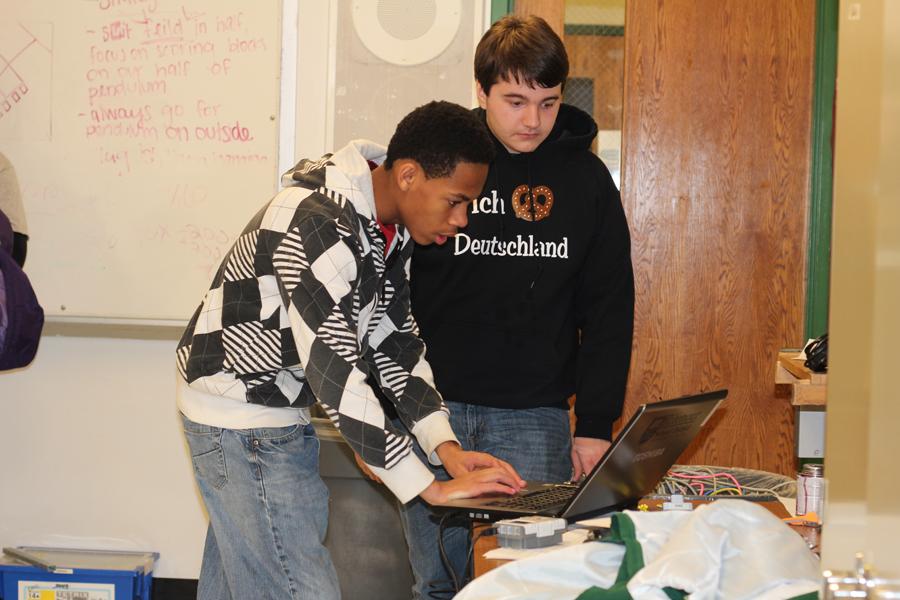 Freshman+Max+Armstrong+works+on+a+laptop+with+a+Pattonville+student+as+the+robotics+team+prepares+for+the+Rockwood+Summit+competition