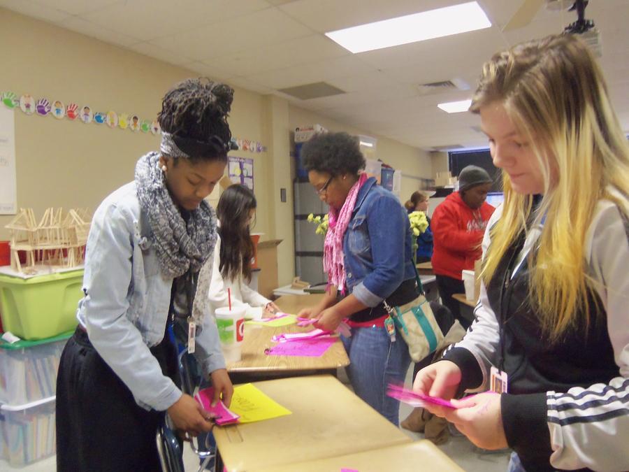 Juniors Onye’ Coleman, Diamond Herron, and Angelica Barnett prepare in class to pass out carnations by creating the name tags that show where each flower will go as part of the Valentine’s day festivitites. Each flower was delivered by hand.