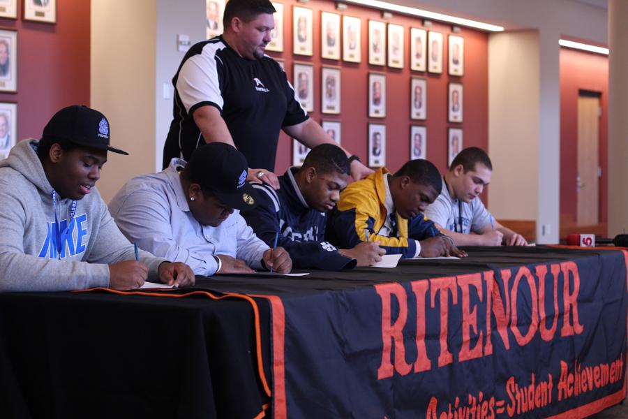 (Left to Right) - Seniors Le’juan Berry, Marlon Griffin, Adewale Adeoye, Devin Alexander and Nate Rifkin sign their letters of intent to play college football with Head Coach Hoyt Gregory. 