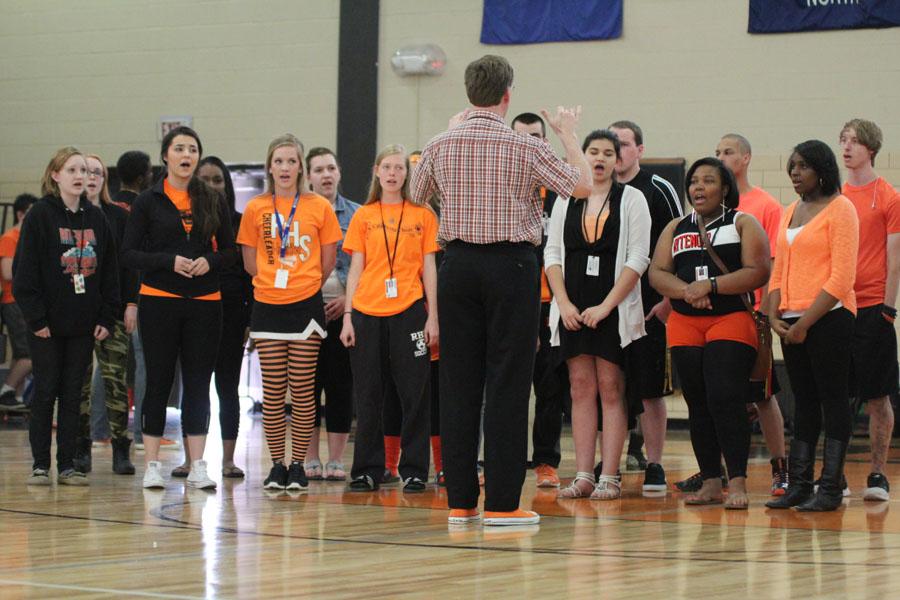 Dr. Richard Bell directs the acapella choir during the national anthem 