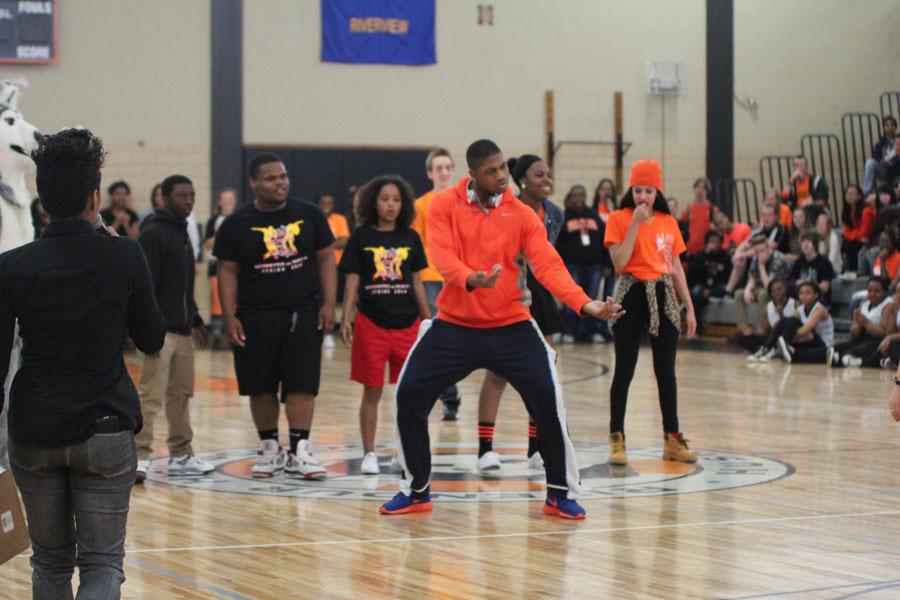 Senior Adwale Adeoye dancing during a dance off at the assembly 