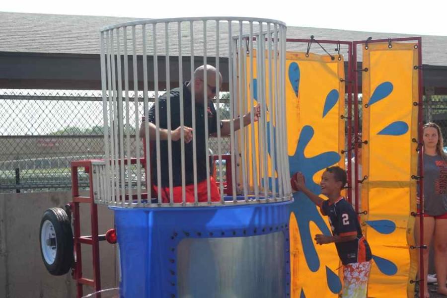New principal Gary Spiller gets dunked in the dunking booth during this years Black and Orange day 