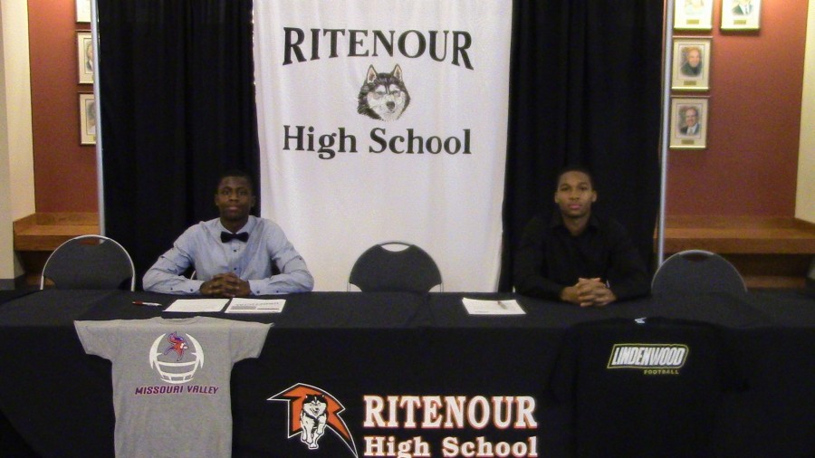 Tre Hollins White and Ricky McCoy sign letters of intent during National High School Signing Day. 