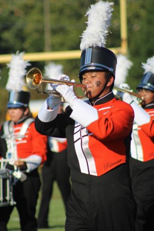 Senior Jake Pagayonan plays the trumpet at a football game.  Pagayonan and the rest of the band will be touring elementary schools to drum up interest in bad. 