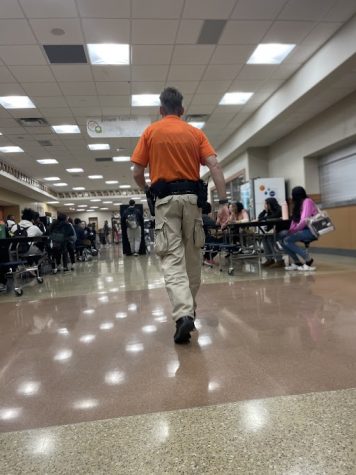 School resource officer (SRO) Elliott Miller walks the foyer during lunch. He is one of the people at Ritenour who carries a weapon. 