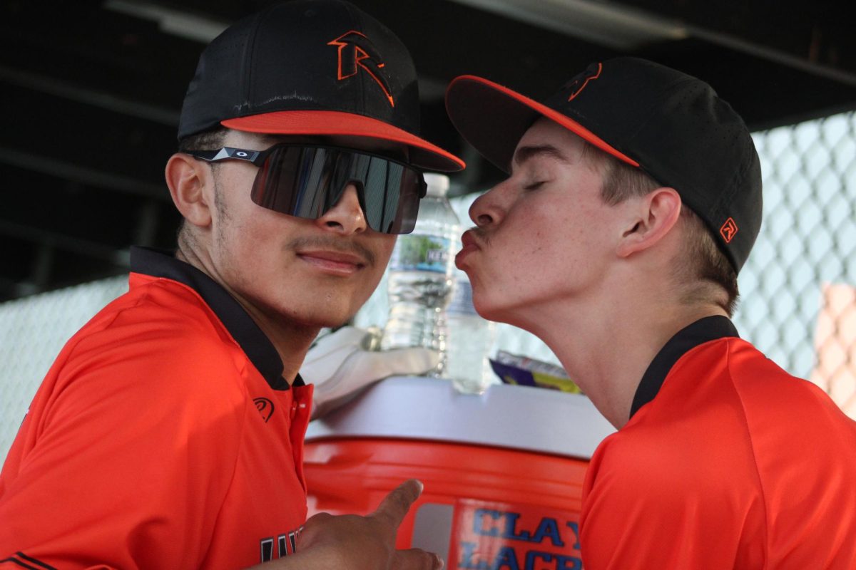 Richard Patton and Will Chosich show off their team bond in the dugout. 