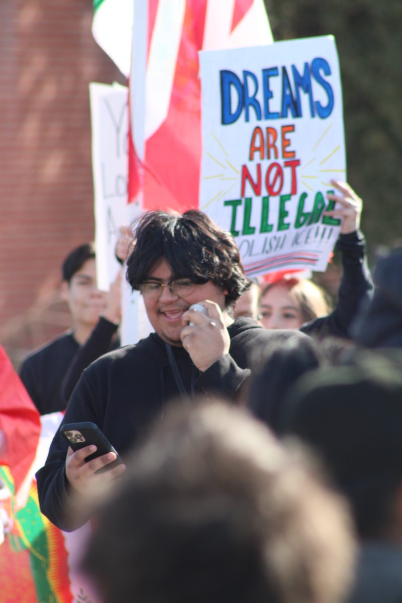 Sophomore David Cabanas speaks to the crowd at the Overland protest of President Trump's immigration policies. Cabanas organized the event and brought in outside groups to help get his message across. 