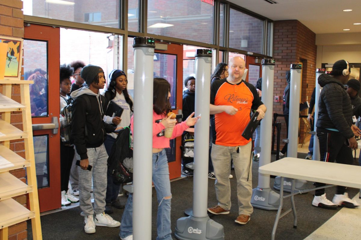 Students enter the building on Friday, November 15 through the new OPENGATE system. Assistant Principal Austin Ferguson is one of the administrators who helps move the students through the line.