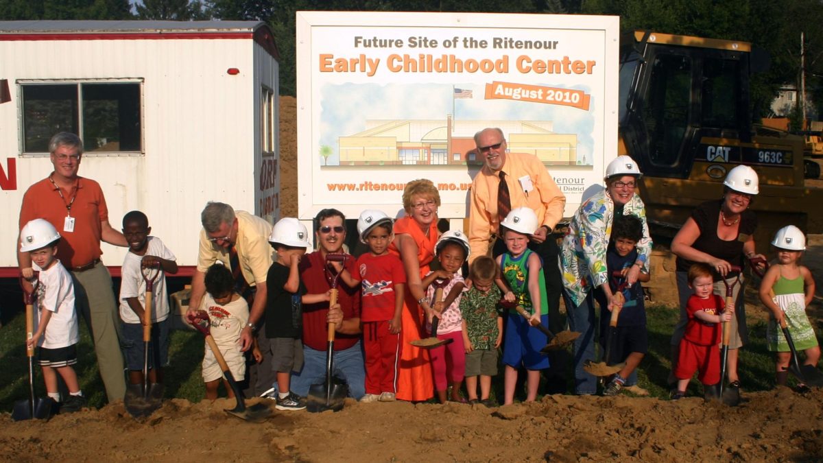 Taken in August 2010, the photo shows the Ritenour School Board members gathering with students who would be the first enrollees at the Early Childhood Center. The Center opened in 2011 and currently serves 235 students. The goal of Superintendent Dr. Chris Kilbride is that eventually all students will enroll there before Kindergarten.