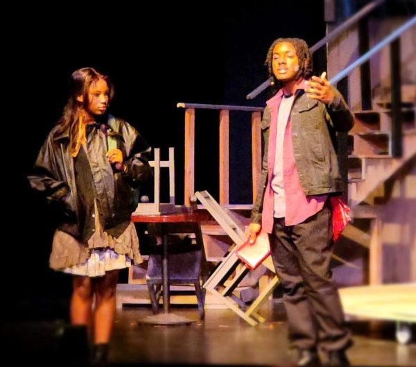 Junior Haiyah Keen (Eurydice) meets senior EJ Davis (Orpheus) in the play, "Hadestown." This is the first meeting of the two main characters who will eventually fall in love. 