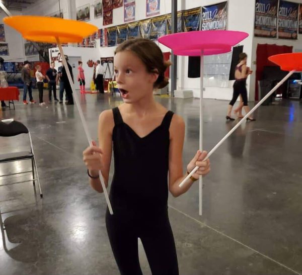 Senior Mia Weicht shows off her plate spinning during circus training in elementary school. Weicht and her sister Shaylee both participated in the program when they were younger, and say that they still use the skills they learned in those classes today.
