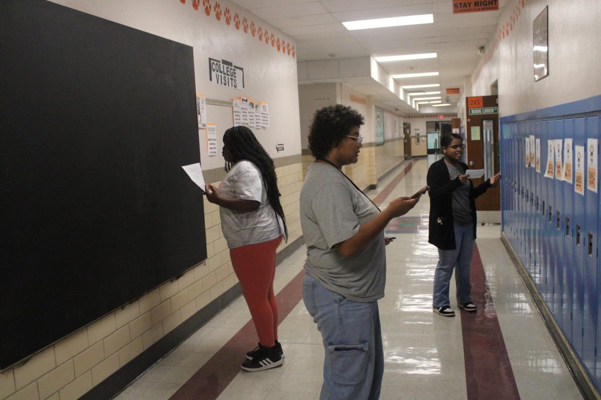 Junior Casey Maney, sophomore Patience Steinbruegge and sophomore Jewel Robinson practice their events by "debating the wall," a technique that the team uses at practice. 