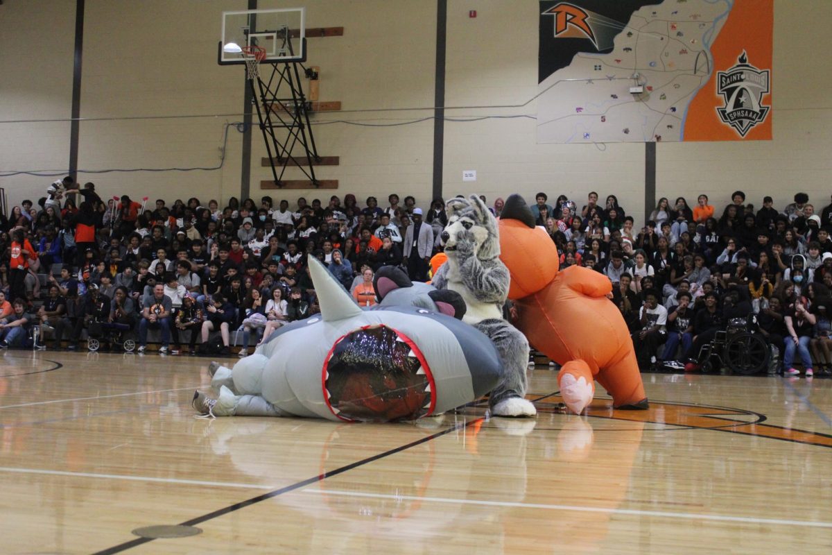 A battle of the mascots takes place as the Ritenour Husky competes against other inflatables in a game of musical chairs. 